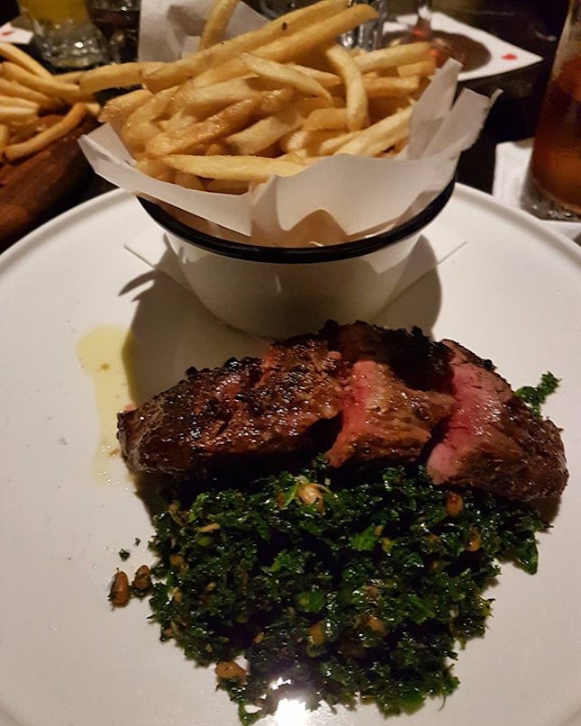 This awesome plate of hanger steak was done perfectly and served with a delicious side of kale cooked with pine nuts and truffle fries.