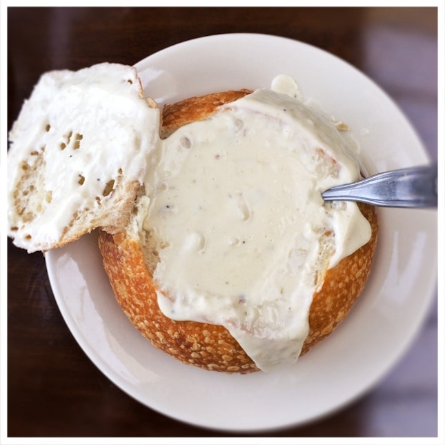 Creamy clam chowder in sourdough bread bowl