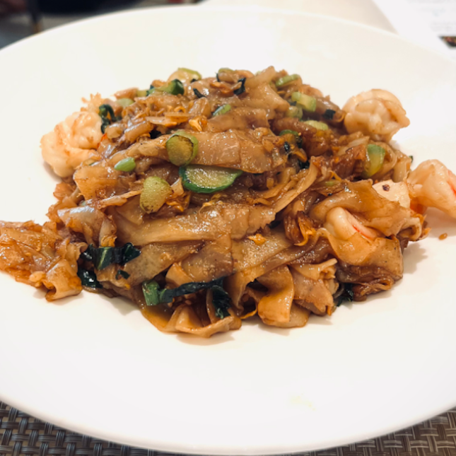Wok hey fried kway teow with diced kai lan and preserved radish ($18)