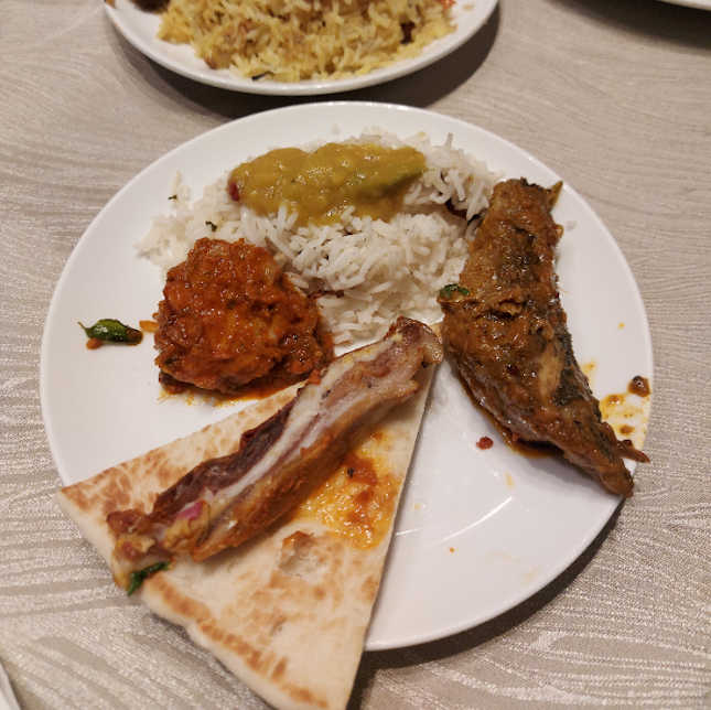 Biryani, naan, chicken and fish curry.