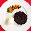 Chocolate cake with vanilla ice cream and passion fruit purée