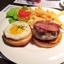 The CBD - Communal Burger Deluxe - gruyere coated patty, bacon, and sunny side up