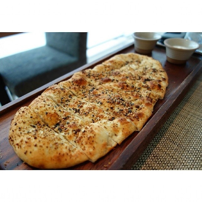 Freshly baked Stone Hearth Flat Bread served with extra virgin oil and dip.
