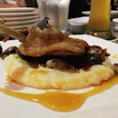 Duck Confit ; Mashed potato, and yummy shiitake mushrooms, and orange sauce.