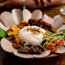 Nasi Campur Bali | Balinese style beef rendang, sambal shredded chicken, sliced beef tossed with sambal, egg tossed with Balado sambal, sweet and spicy tempeh, stir-fried long beans and beef skewers with basted home sambal