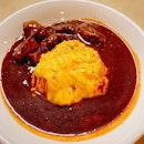 Omu rice mountain, surrounded by a moat of beef sauce, with tender chunks of beef!