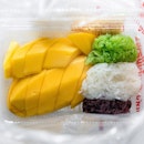 Incredibly sweet and juicy mango with three kinds of sticky rice ( white, black, and green color from pandan leaves).