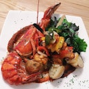 Boston lobster kebabs harissa served with roasted vegetables and potato skewers.