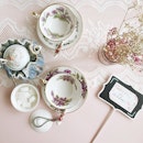 Dainty teapot, tea cups and fragrant tea scent.