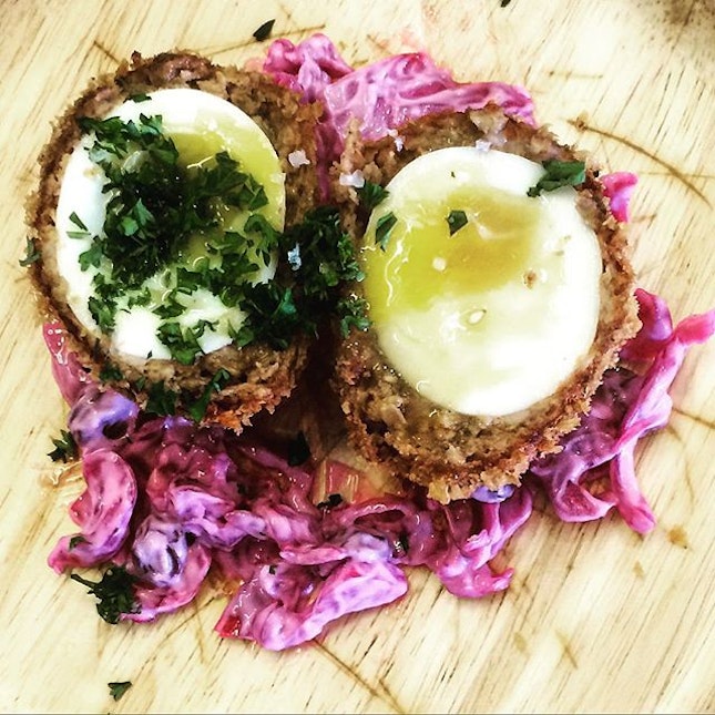 Scotch Egg Breaded Minced Pork with Soft Boiled Egg served with Purple Cabbage Colesaw  A Scotch Egg is a delicacy that was made out of necessity in the Middle Ages by Scottish farmers and sheperds as a form of 'packed' lunch from home.
