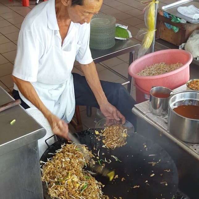 The famous Char Kway Teow in Kampar; The uncle who sat on the stool while whipping up the dish!
