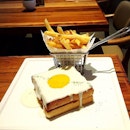Toast with ham and cheese, topped with a sunny egg (or known as Croquette Madame, RM19), served with fries.