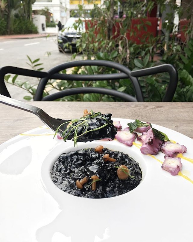 Squid ink risotto ⚫️ stains your lips and teeth yet tastes so good ❤️ loved the purple octopus at the side 👌🏻😛