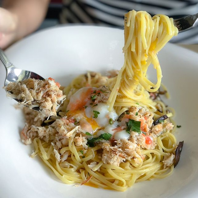 Signature crab pasta [$15.80++] Sautéed crab meat aglio olio topped with spicy cod roe and poached egg, the pasta also comes with sliced shiitake mushrooms.