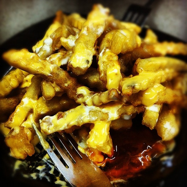 Sharing a plate of sinful cheese fries at 2AM.