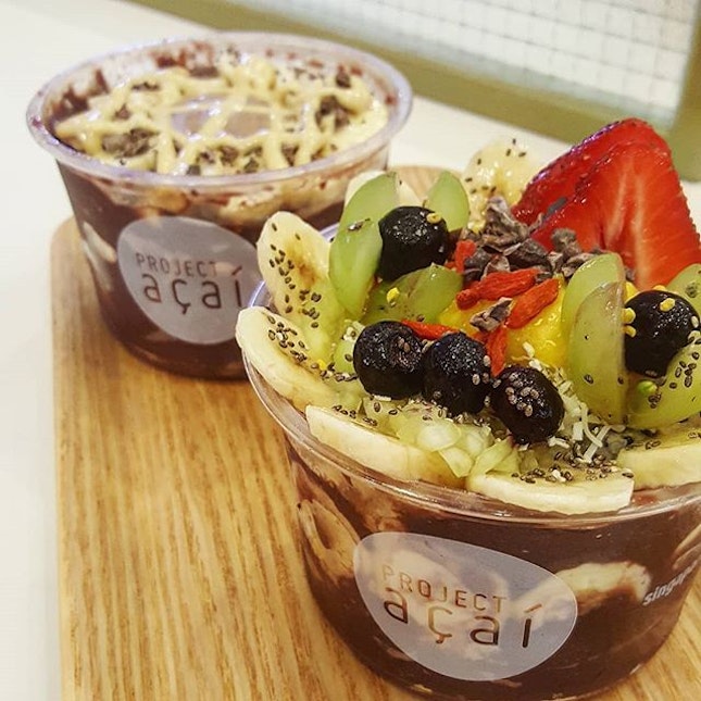 Pretty Signature Acai Bowl topped with lots of fruits 🍌🍓, and another with cashew and almond butter (both at $14.50 each for L).
