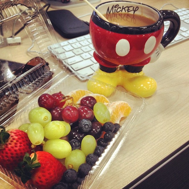 my berries breakfast from caffee macs + tea in mickey pants! on my very messy table!