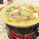 This is steamboat, but atypical because of the

1) Pumpkin Soup Base 
2) Ingredients such as beancurd with a juicy meat filling in the centre and meatballs that has another inner meat filling
3) Servers who dump the ingredients for you in the order it should cook after you finish each ‘phase’.