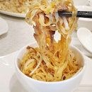 Springy thin mee pok stired fried with the remaining duck meat from Peking.
