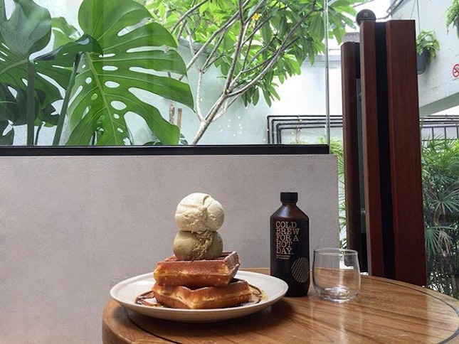 Waffles with ice cream and coffee loving their indoor back seating area.