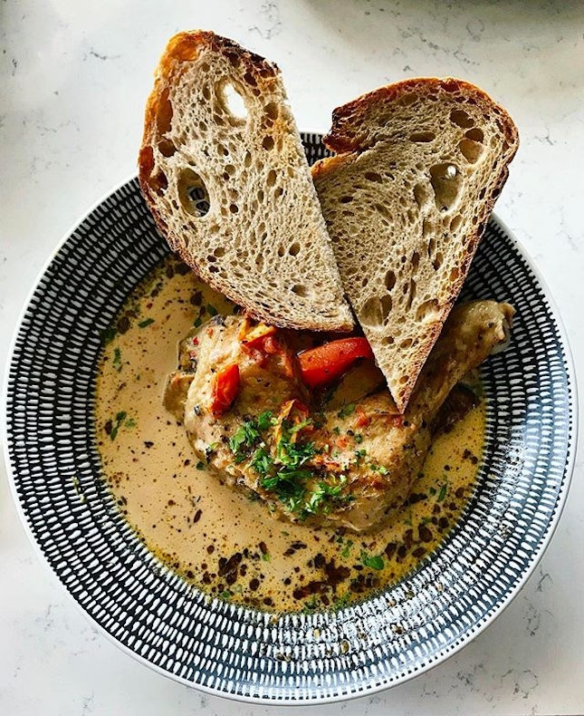 Atlas CoffeeHouse - All Day Brunch - Summer Chicken Stew (💵S$18) Slow roasted Chicken Thigh with Herbed Potatoes & Carrots served with Sundries-Tomato Cream Broth & dipping Sourdough.