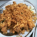 A beautiful mess of fried cereal on top of a bed of deep fried mantis prawn.