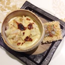 Baked Japanese Pearl Rice with Seafood and Cheese served in Young Coconut.