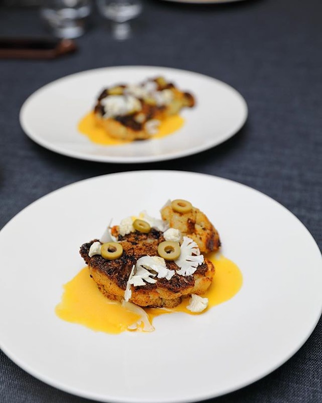[Dearborn Supper Club] - Grilled Cauliflower Steak topped with pickled cauliflower and olives.