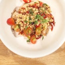 Chilled fregola salad with sun-dried tomatoes, cherry tomatoes, roast chicken, and roughly julienned Italian parsley and basil.